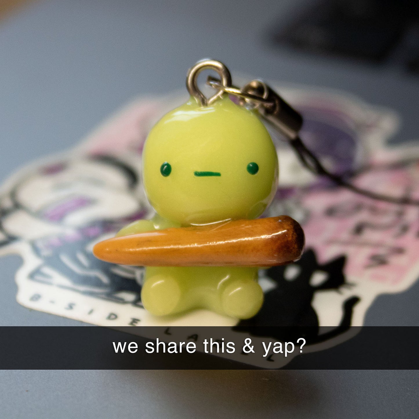 green guy with funny stick phone charm/keychain